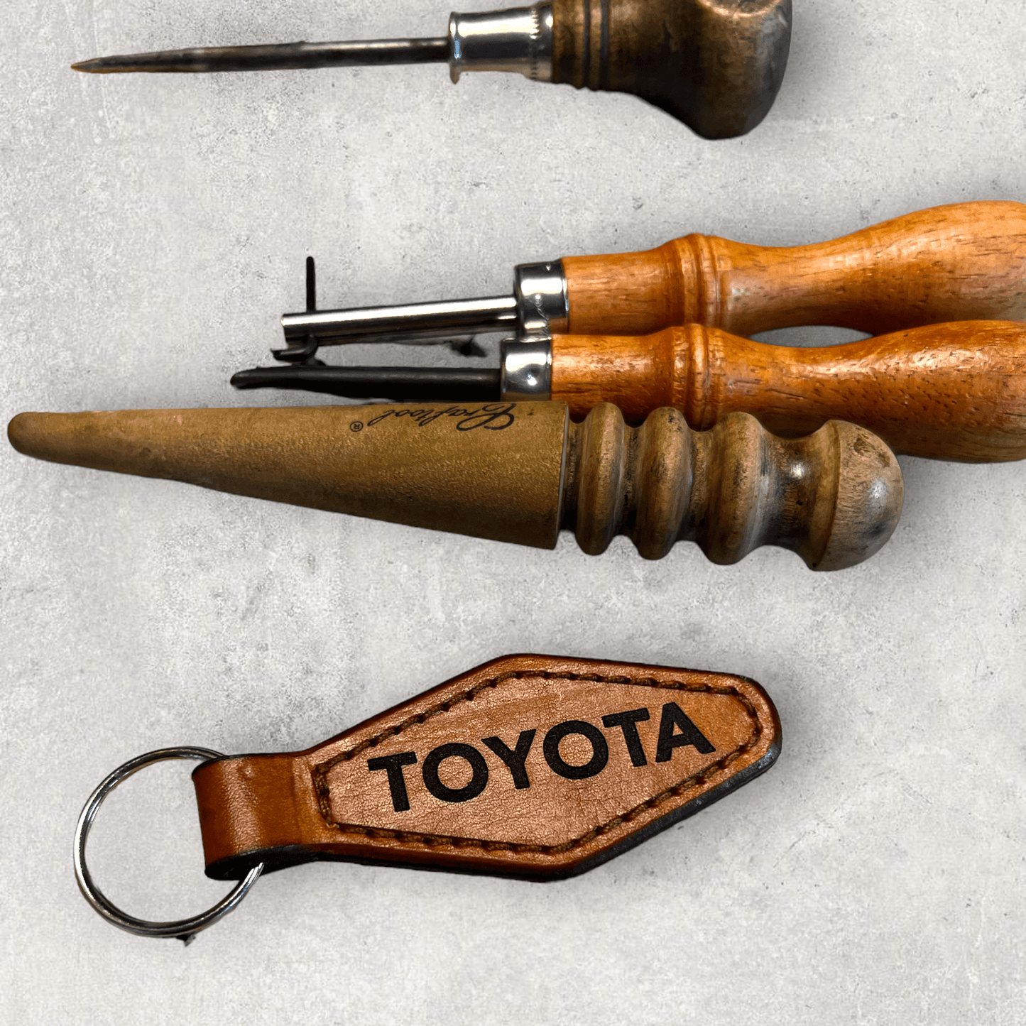 Toyota Diamond leather Keychain with leather making tools showing hand crafted nature - Shop Battle Born Clothing